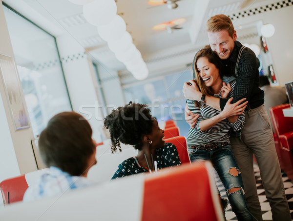 Young multiracial friends enjoying in the diner Stock photo © boggy