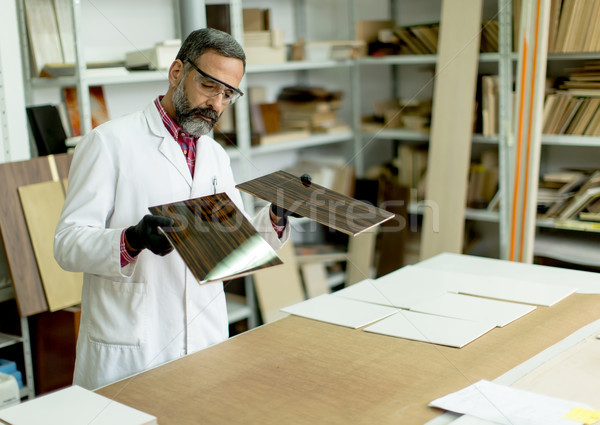 Engineer in the laboratory examines ceramic tiles Stock photo © boggy