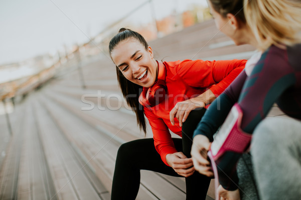 Two attractive female runner taking break after jogging outdoors Stock photo © boggy