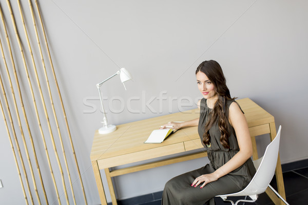 Woman sitting by table in the room Stock photo © boggy