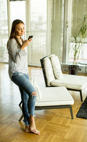 Young blond woman looking at cell phone Stock photo © boggy