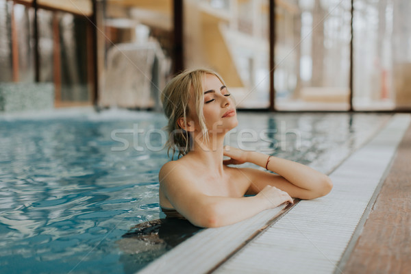Pretty young woman relaxing on the poolside Stock photo © boggy