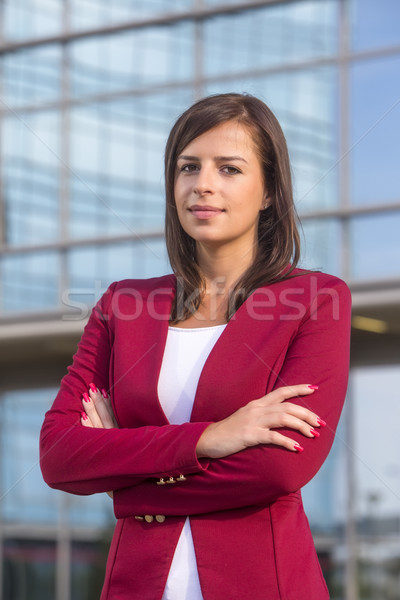 Portrait of young businesswoman in front of office guilding Stock photo © boggy