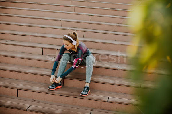 Attractive female runner taking break after jogging outdoors Stock photo © boggy