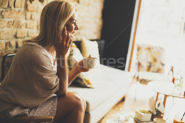 Stock photo: Young blond woman in the cafe