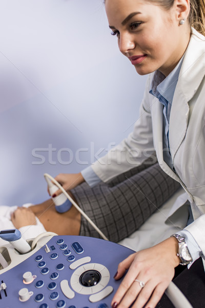 Young femal doctor working on ultrasounds keyboard Stock photo © boggy
