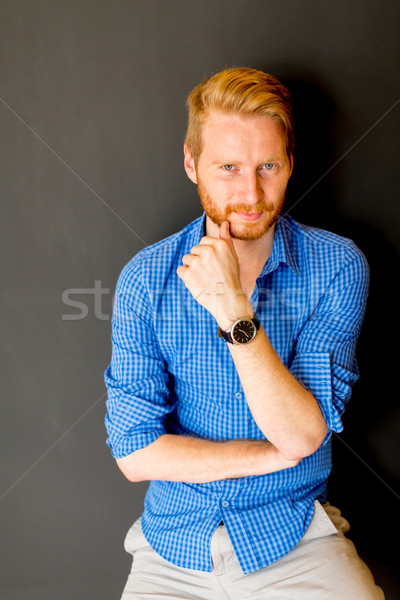 Portrait of ginger young man against wall Stock photo © boggy