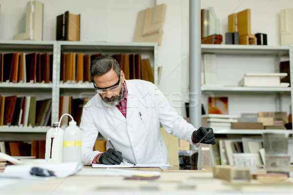 Engineer in the laboratory examines ceramic tiles Stock photo © boggy