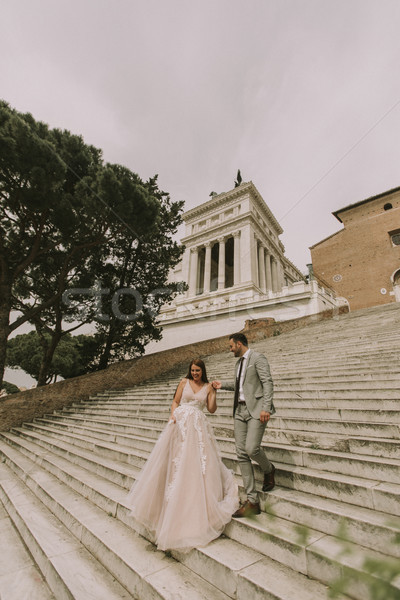 Bride and groom walking outdoors at Spagna Square and Trinita' d Stock photo © boggy