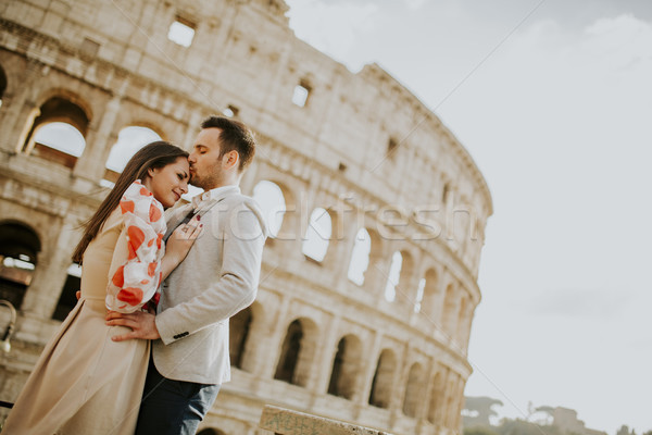 Loving couple visiting Italian famous landmarks Colosseum in Rom Stock photo © boggy