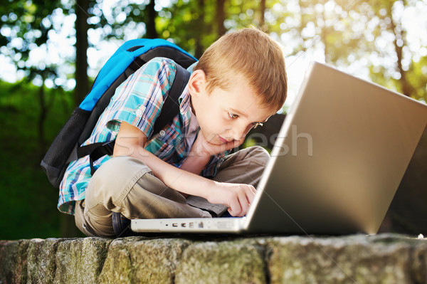 Boy focused on notebook Stock photo © bogumil