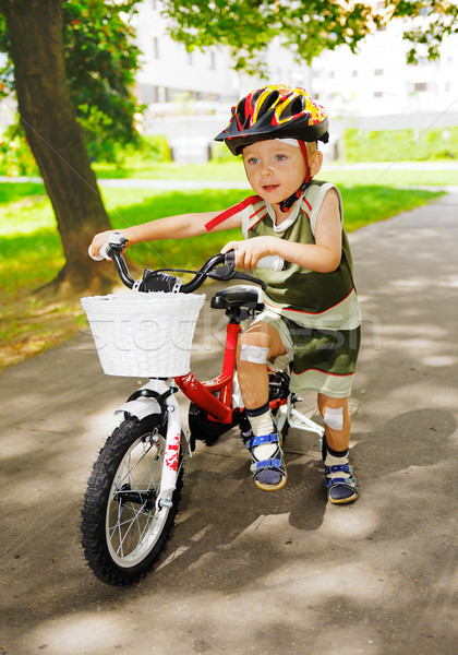 Young kid with injured knees is learning to ride a bike Stock photo © bogumil