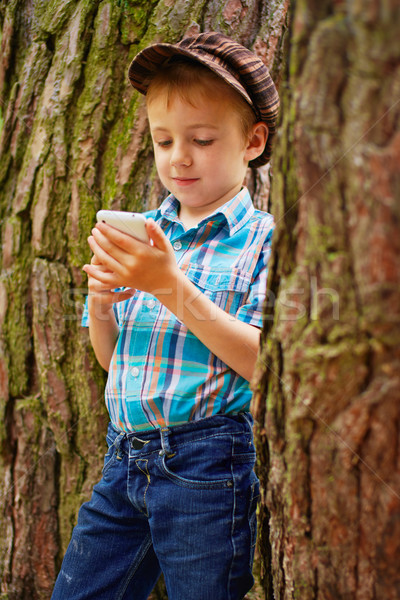 Young boy reading sms Stock photo © bogumil