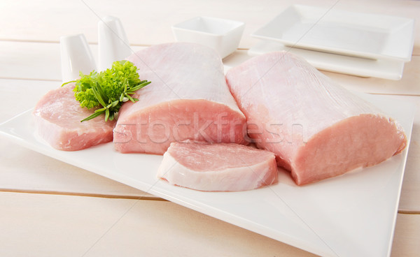 Raw pork chop with tableware Stock photo © bogumil