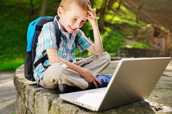 Stock photo: Boy delighted with notebook