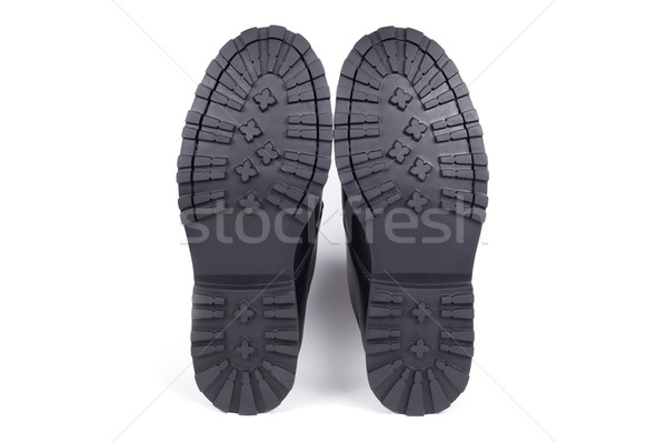 Sole of man's boots isolated on a white background shadow below. Stock photo © borysshevchuk