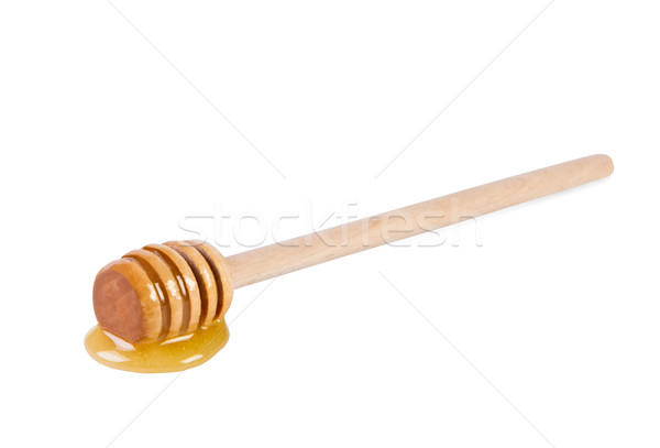 Wooden stick with honey on white background. Stock photo © borysshevchuk