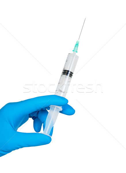 Hand in glove with medical syringe. Stock photo © borysshevchuk
