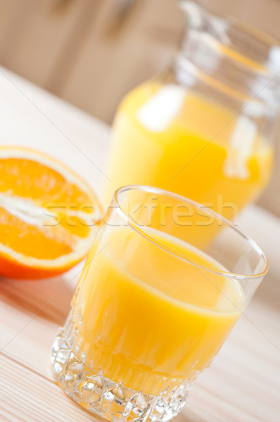 Glass and pitcher of juice on table. Stock photo © borysshevchuk