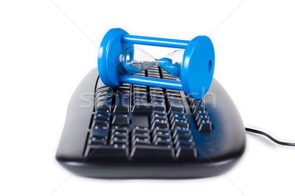 The keyboard with a sand-glass isolated on a white background. Stock photo © borysshevchuk