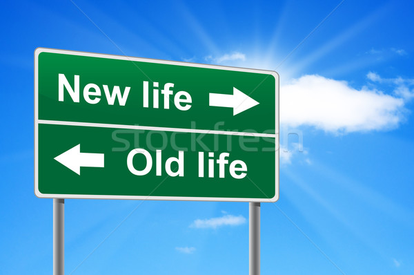 Stock photo: New life old life road sign on background clouds and sunburst.