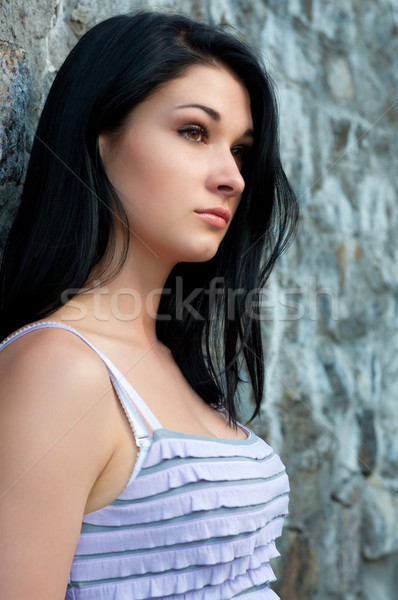 Sad girl against the wall. Stock photo © borysshevchuk