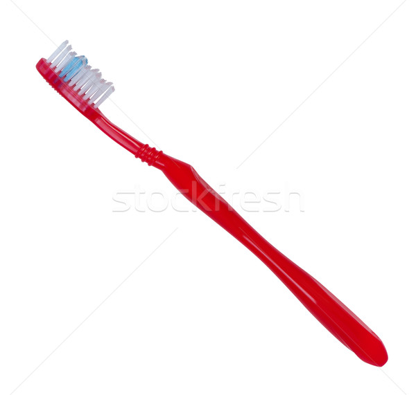 Toothbrush red color on white background. Stock photo © borysshevchuk