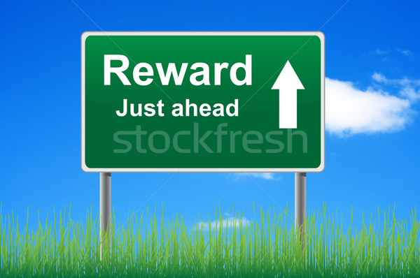 Reward road sign on sky background, grass underneath. Stock photo © borysshevchuk