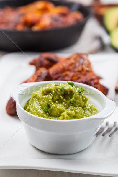 Grilled chicken legs and wings with guacamole Stock photo © brebca