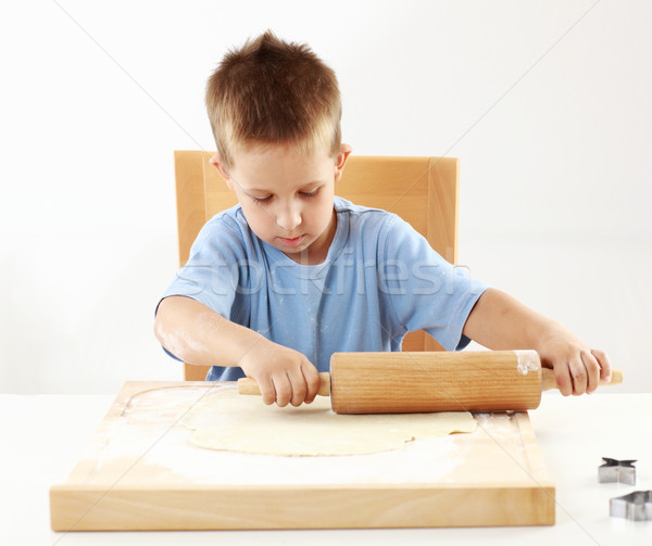 Small boy rolling dough for cookies  Stock photo © brebca