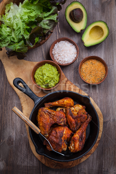 Grilled chicken legs and wings with guacamole Stock photo © brebca