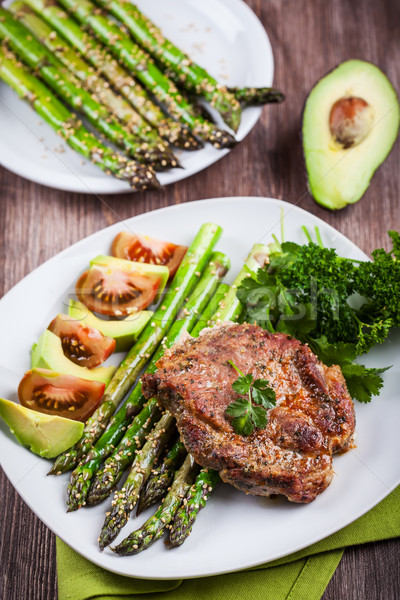 Stock photo: Glazed green asparagus with grilled pork chop