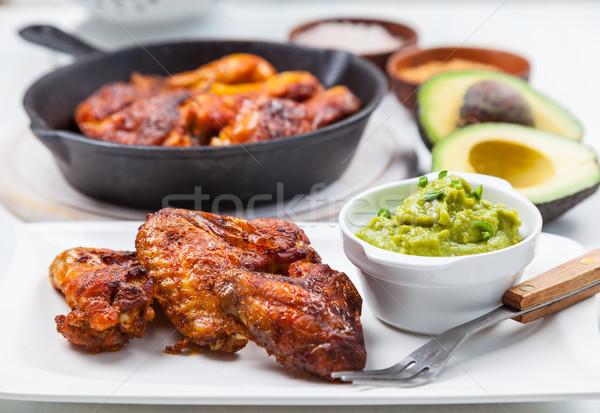 Grilled chicken legs and wings with guacamole Stock photo © brebca