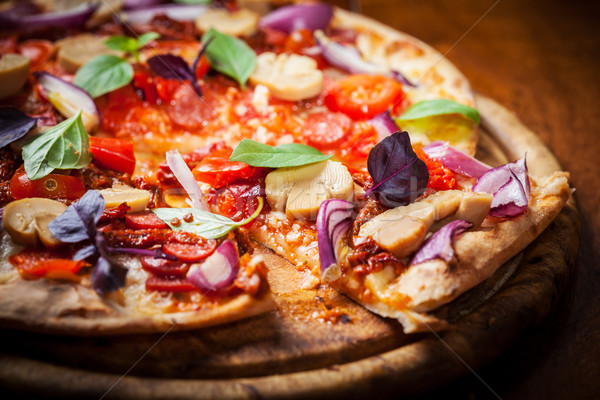 Homemade pizza with dried tomatoes and salami  Stock photo © brebca