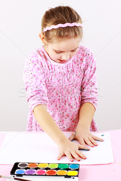 Stock photo: Cute girl painting with watercolor