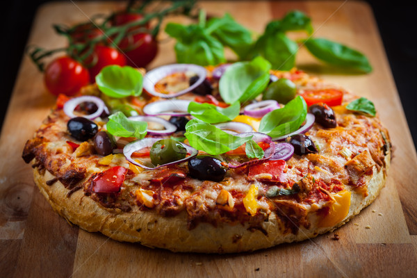 Traditional homemade pizza with tomatoes and olives Stock photo © brebca