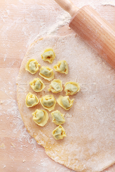 Dough with raw tortellini and rolling pin Stock photo © brebca