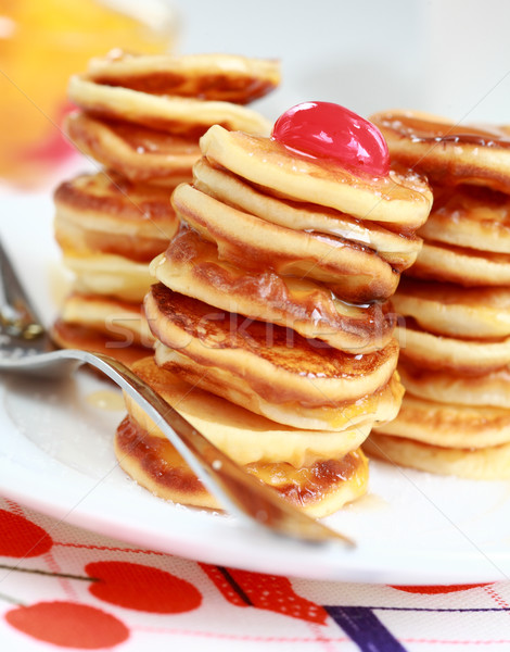 Sweet mini pancakes with pancake maker Stock photo © brebca