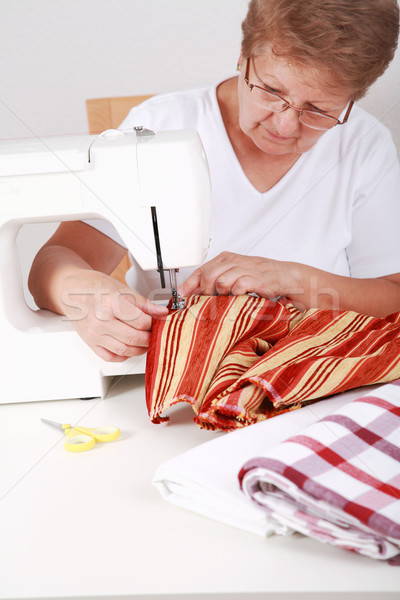Elderly woman sewing Stock photo © brebca