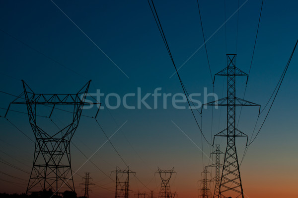 Elétrico torres pôr do sol longo linha eletricidade Foto stock © brianguest