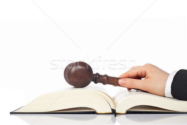 Holding a wooden gavel over the law book Stock photo © broker