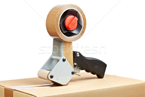 Stock photo: Packaging tape dispenser and shipping box