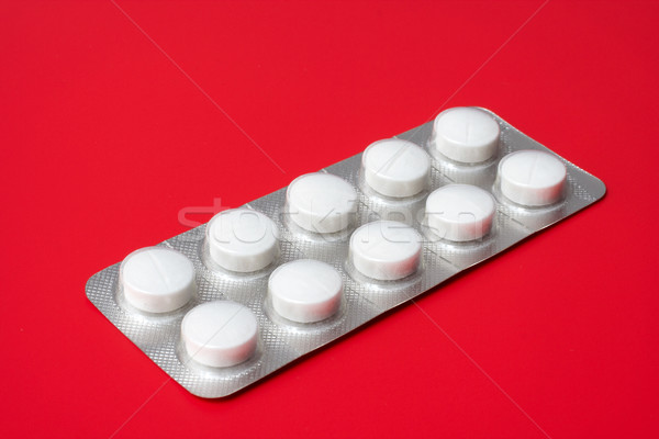 blister pack containing tablets on a red background Stock photo © broker