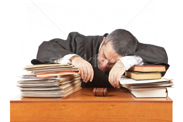 Stock photo: Male judge sleeping over the files