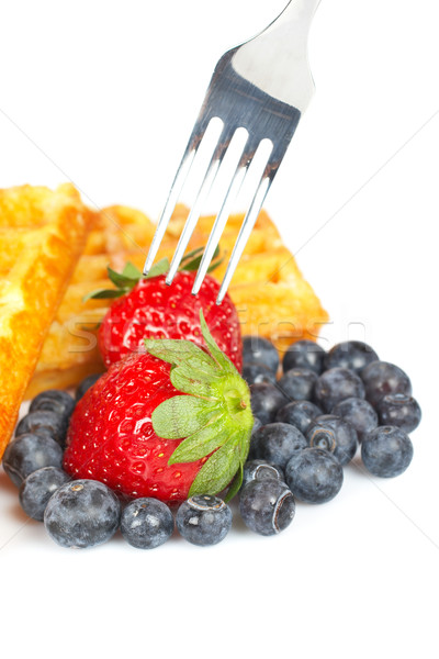 Waffles, blueberries and the fork pricking the strawberry Stock photo © broker