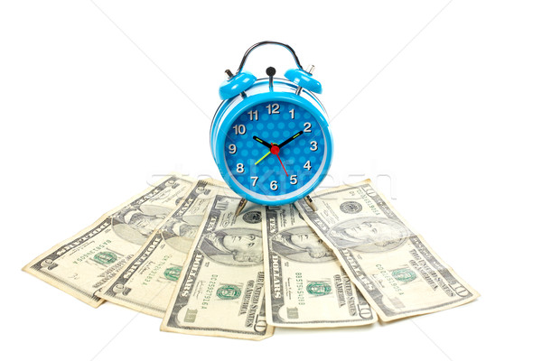 Alarm clock over a fan of money Stock photo © broker