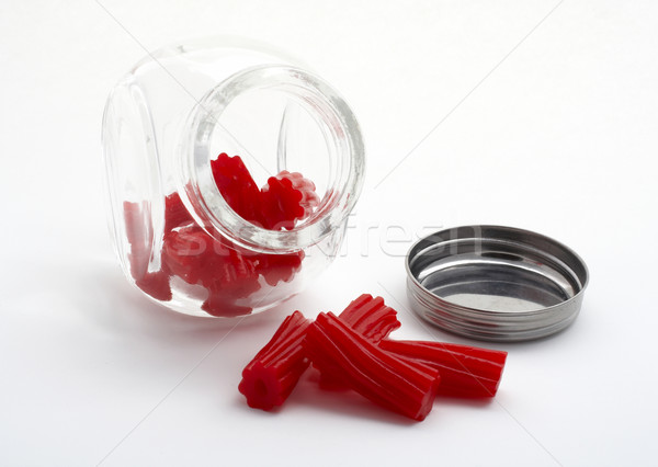 Pieces of red licorice on glass jar Stock photo © broker