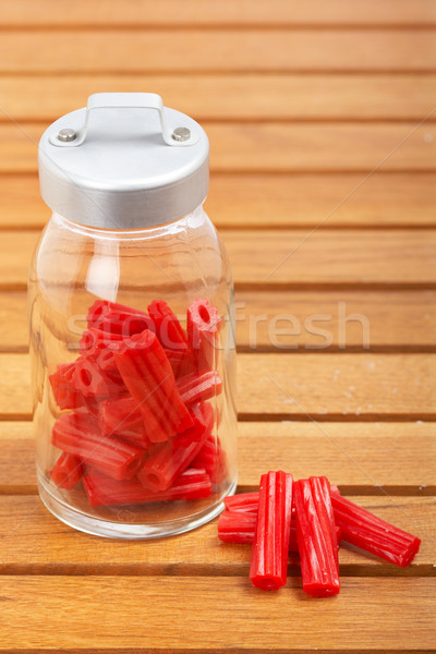 Red licorice on glass jar Stock photo © broker