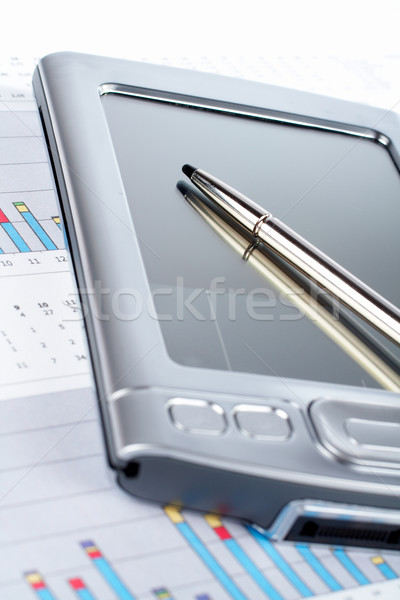 Personal digital assistant on market financial chart background Stock photo © broker