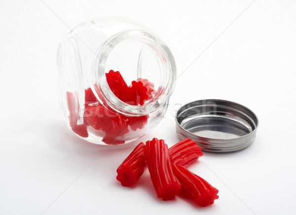 Pieces of red licorice on glass jar Stock photo © broker